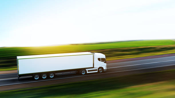 semi-truck with trailer driving on road - speed horizontal commercial land vehicle automobile industry imagens e fotografias de stock