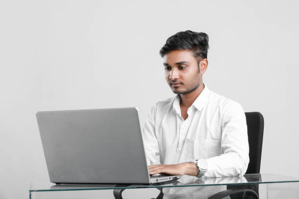 istock young indian man working at office 1165326707