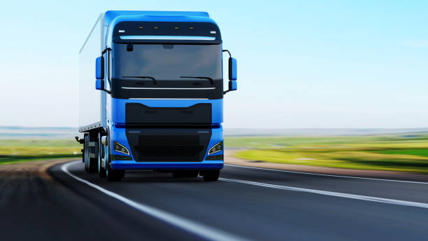 istock semi-truck with trailer driving on road 1165327392