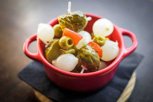 spanish banderillas, skewers with pickling olives, garlic, pickles, onion and red pepper, tapas stock photo