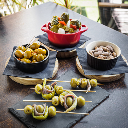 different types of spanish tapas, banderillas, gildas, olives and almonds