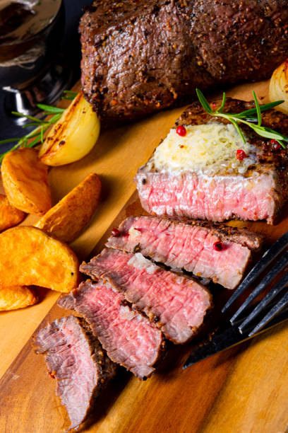 istock rustic medium butter beef steak with herbs and potato wedges 1165328320