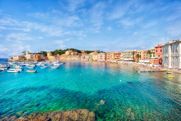 Public beach of Italian Sestri Levante in summer panorama of Bay of Silence, Sestri Levante, Liguria, Italy bay of water stock pictures, royalty-free photos & images