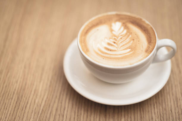 istock Hot coffee cappuccino latte art on wooden background 1165330033