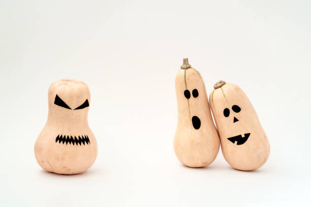 istock Funny scary face Halloween pumpkins on white background. 1165330794