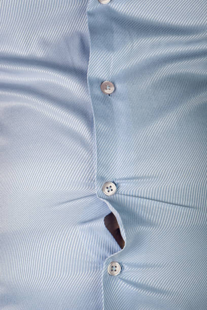 istock Overweight Man with Bulging Shirt Buttons 1165332008