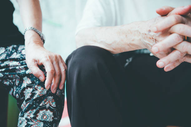 istock Senior man sitting on chair with his hands on knees 1165333634
