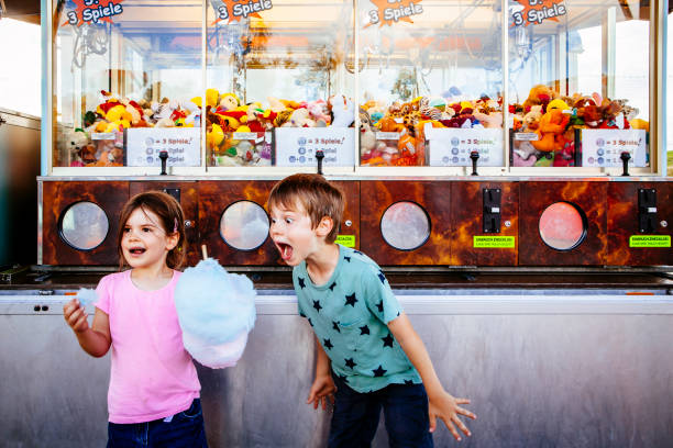 istock Children eating cotton candy at the carnival 1165333932