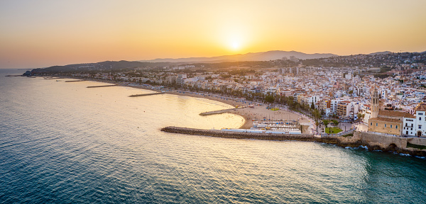 Aerial view of Sitges Village from above the sea at sunset. Catalonia, Spain