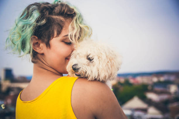 istock Girl with a puppy in her hand 1165335125