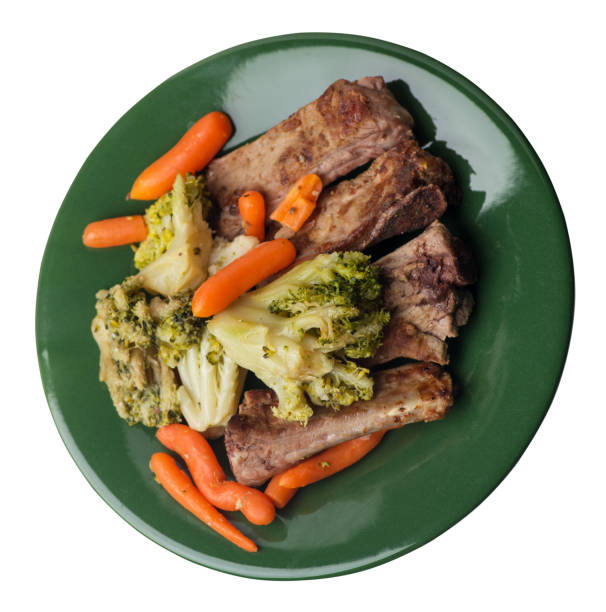 istock grilled pork ribs with broccoli cabbage, carrots and garlic on a plate. fried   ribs with vegetables on a white background. hearty rustic food top view 1165335575