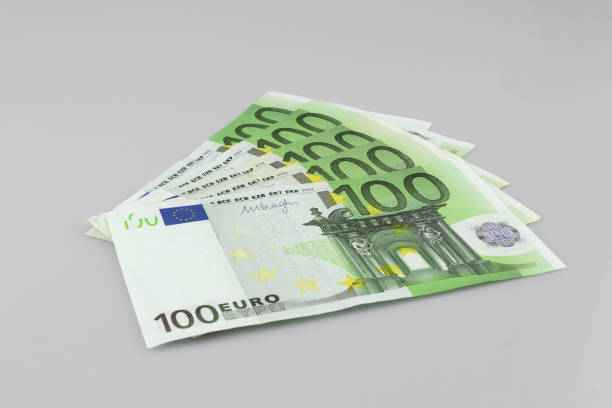 100 euro bills euro banknotes money. european union currency.  isolated background. - european union coin european union currency coin isolated objects imagens e fotografias de stock