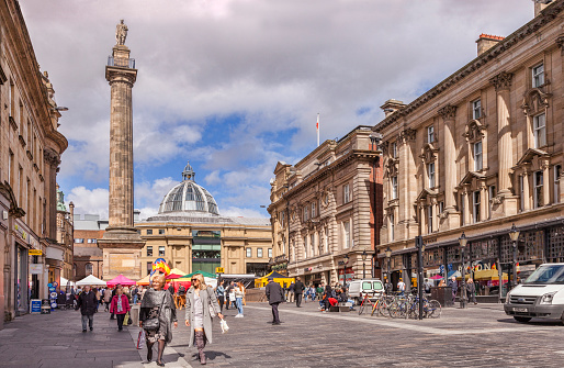 22 April 2016: Newcastle-upon-Tyne, Tyne and Wear, England, UK - Greys Monument and shoppers in Grey Street, regularly voted one of the best streets in England architecturally.
