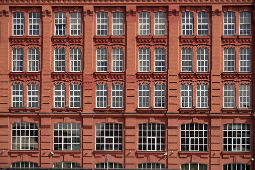 Facade of new house, modern windows red brick wall, background, full frame