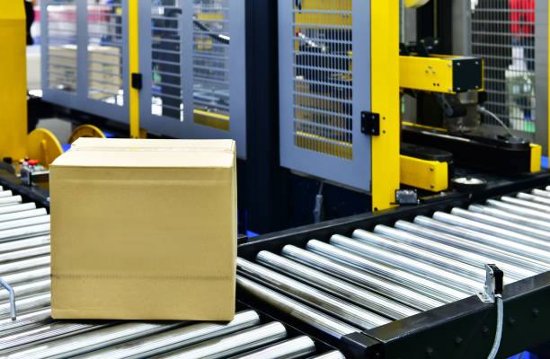 istock Cardboard boxes on conveyor belt in distribution warehouse 1165342378