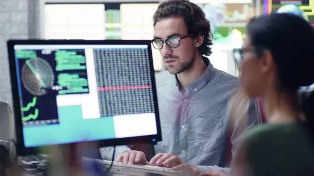 Photo of Researchers with multiple monitors