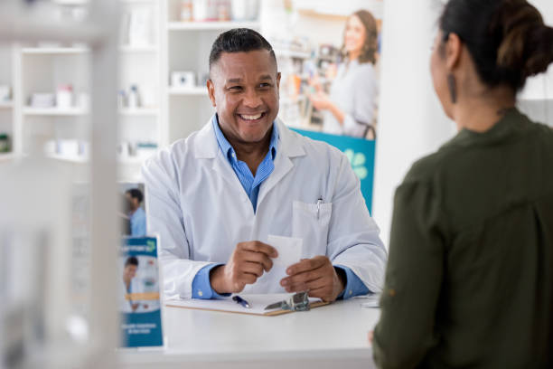 istock Confident male assists mid adult customer 1165344731