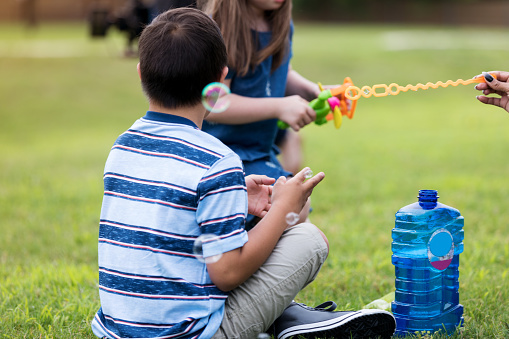 Asian kids play with clay molding shapes, learning through play