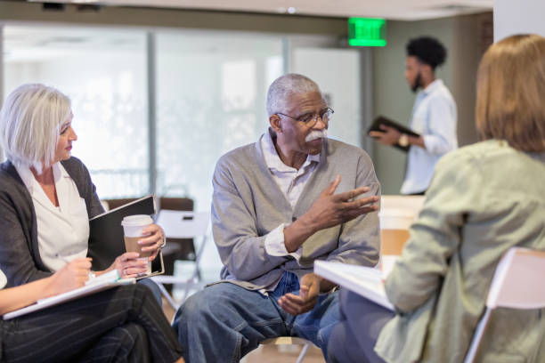 istock Senior man gestures as he speaks to unseen person 1165345131