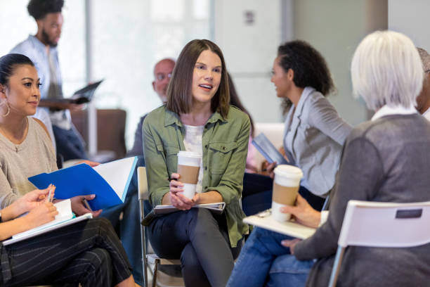 istock New member of homeowners association introduces herself in small group 1165345170