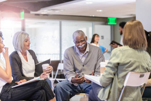 istock Senior neighbor makes joke at community meeting 1165345175
