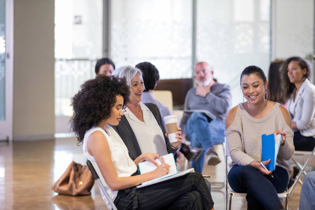 istock Waiting for meeting to start, small group members laugh together 1165345184