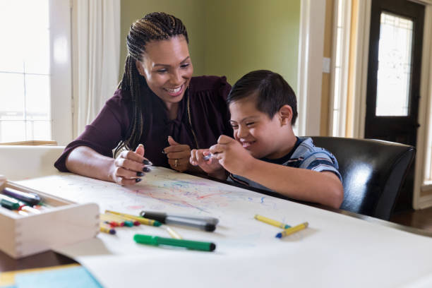 istock Therapist encourages special needs boy as he learns new skill 1165345427
