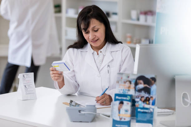 istock Pharmacist fills prescription 1165346063