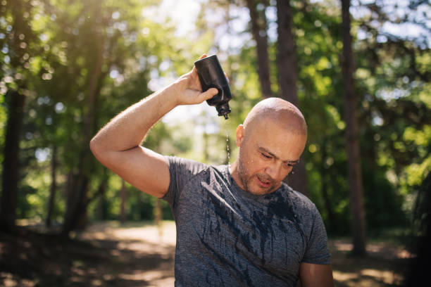 istock Athlete cooling down after a workout in the hot sun 1165346373