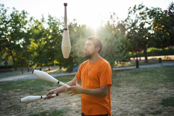 istock Young adult juggler training at the park 1165346597