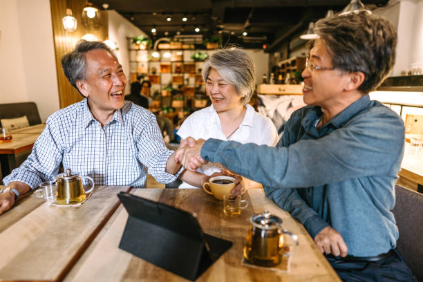 istock Business people shaking hands in caffee shop 1165352172