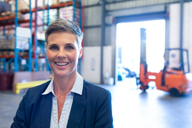 istock Female manager looking at camera in warehouse 1165352504