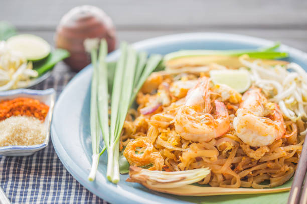 Pad Thai - Rice noodles with shrimps and vegetables close-up on the table. Pad Thai - Rice noodles with shrimps and vegetables close-up on the table. top view of a horizontal peoples alliance for democracy stock pictures, royalty-free photos & images