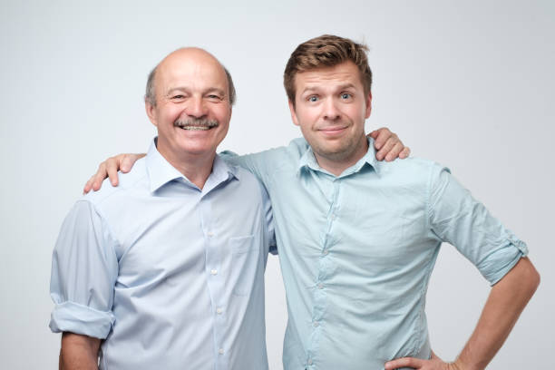 istock Cheerful father and son hugging and posing together 1165354056