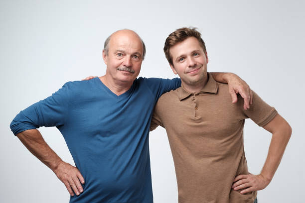 istock Cheerful father and son hugging and posing together 1165354403