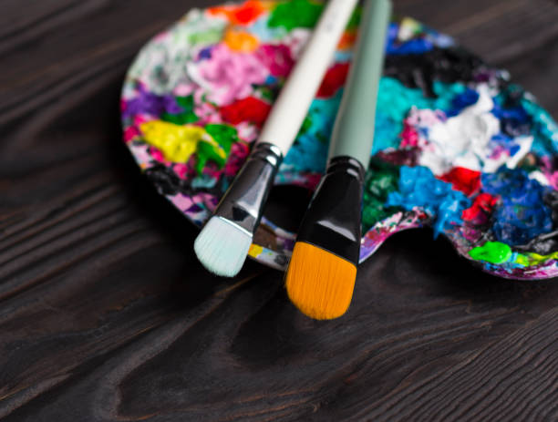 istock Brushes and art palette with paint 1165355377