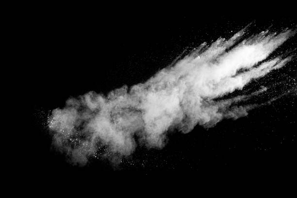 istock White powder explosion isolated on black background. White dust particles splash.Color Holi Festival. 1165360567