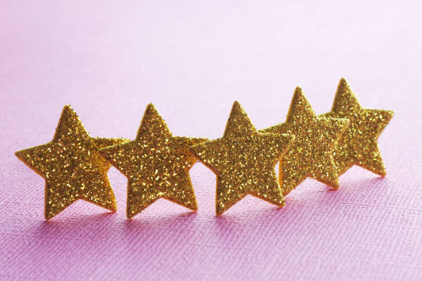 istock five golden stars on a pink background. concept top quality. copy space. 1165361304