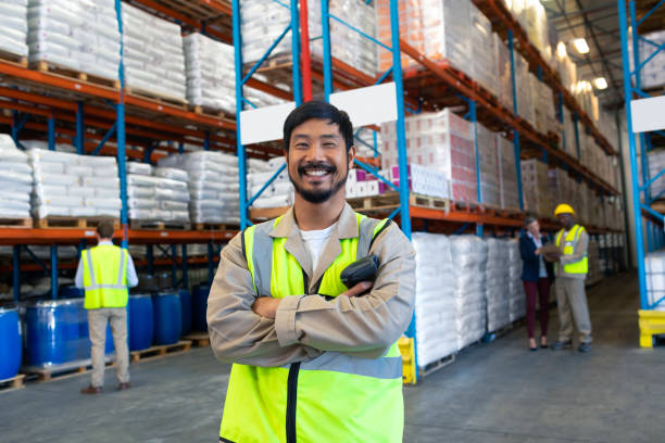 istock Male worker standing with arms crossed and looking at camera in warehouse 1165362641
