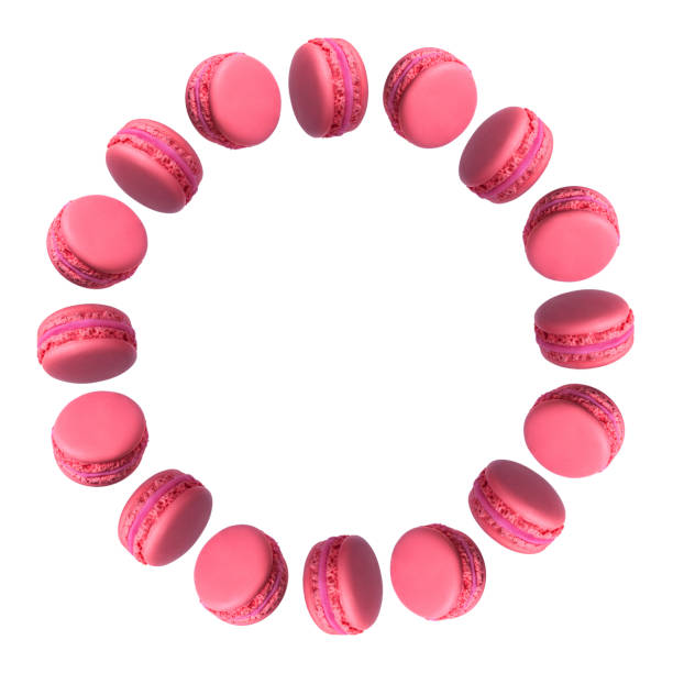 Round frame of pink french macarons cakes isolated on white background.