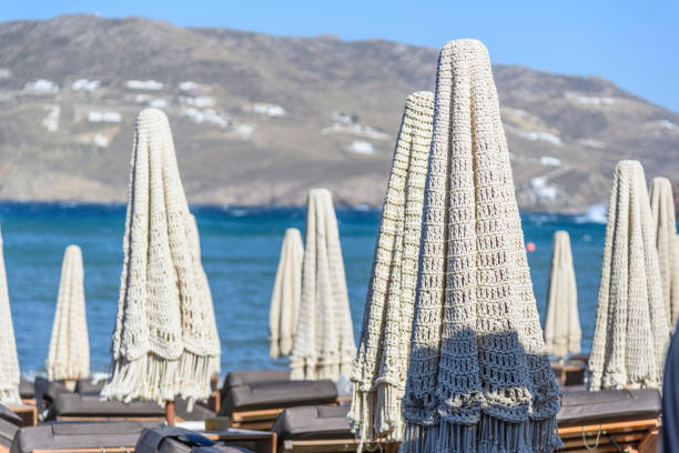 Early morning in restaurant near sea. Folded umbrellas above the tables in the restaurant