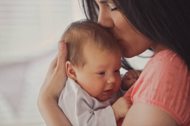 istock New mum kissing her baby 1165363942