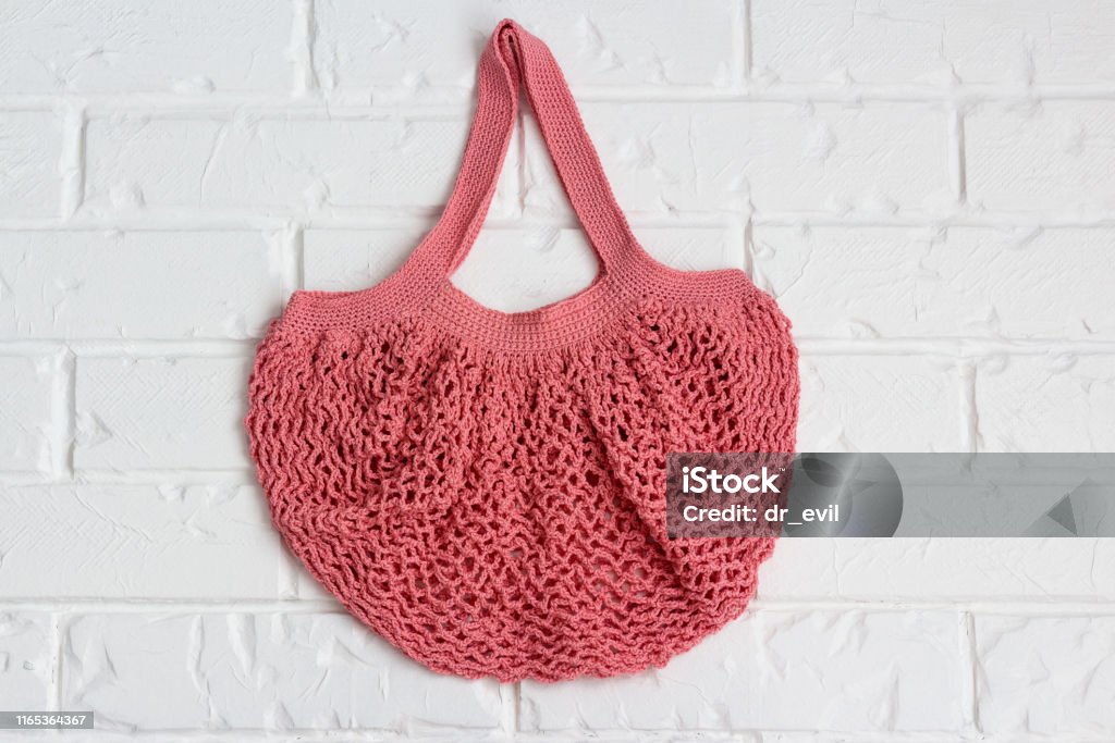 Knitted String Bag Weighs On A Vintage Brick Wall Stock Photo