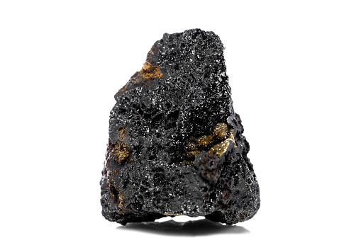 Raw and unrefined manganese ore in front of white isolated background, geology and mining