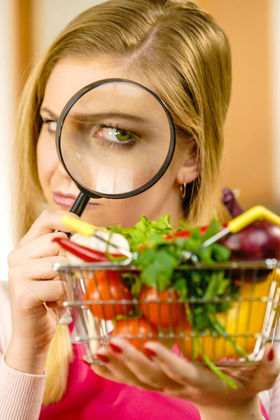 istock Woman investigating shopping backet with vegetables 1165368036
