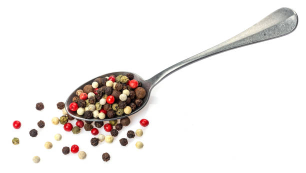 istock Pepper mix. Different peppercorns in spoon isolated on white background 1165371442