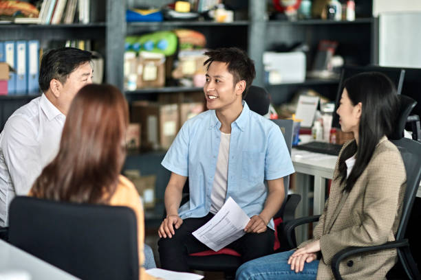 istock Smiling Asian Small Business Entrepreneurs in Discussion 1165373932