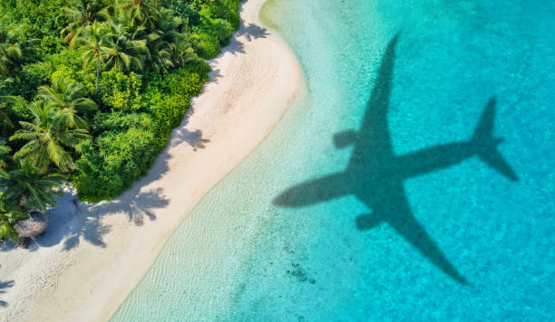 istock Travel concept with airplane shadow and beach 1165375366