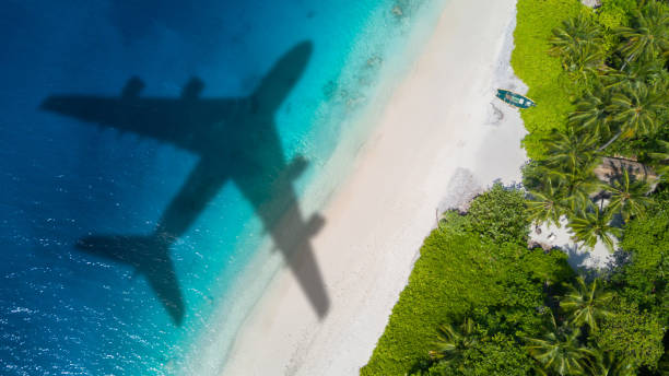 istock Travel concept with airplane shadow and beach 1165375411