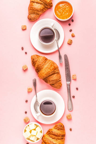 istock Coffee and croissants on pastel background 1165375513